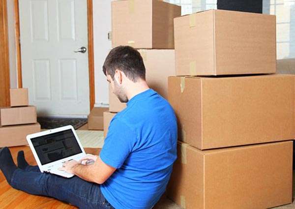 Boy,laptop and Moving boxes