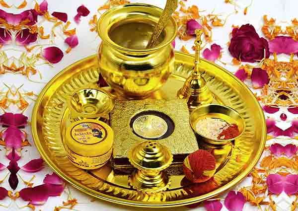 Place golden-colored puja thali